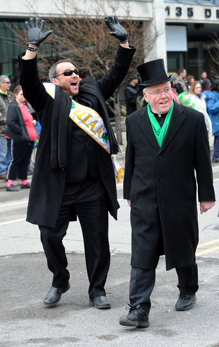 Bishop Richard Malone and Father David Richards march north on Delaware Avenue during the annual St. Patrick's Day Parade. (Dan Cappellazzo/Staff Photographer)